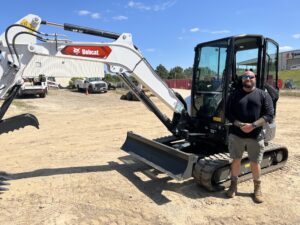 Roger Schmidt, owner of Code 3 Outdoors, LLC with his brand-new Bobcat mini excavator he had financed with OCS.
